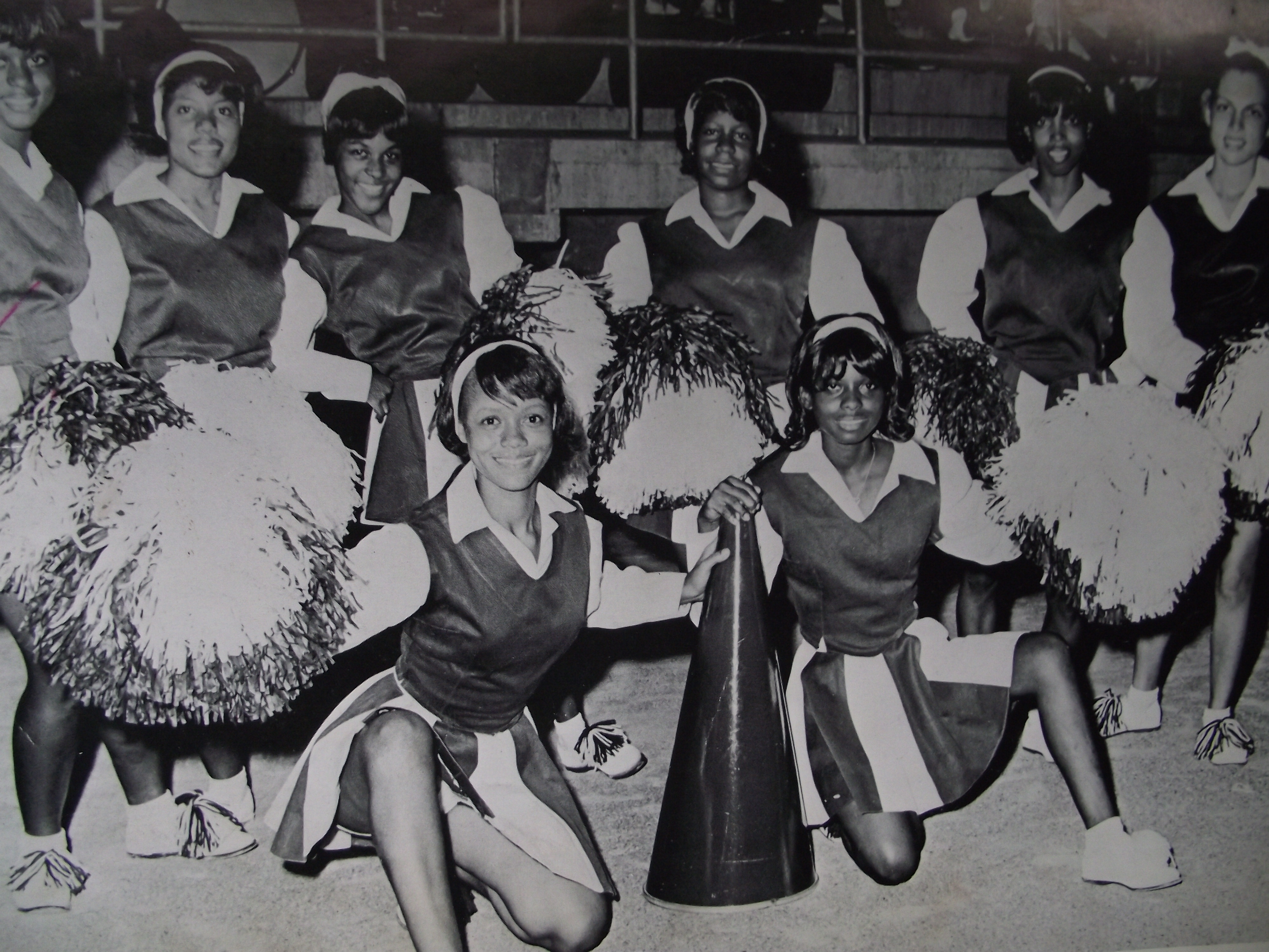 A group of women in uniforms pose for the camera.