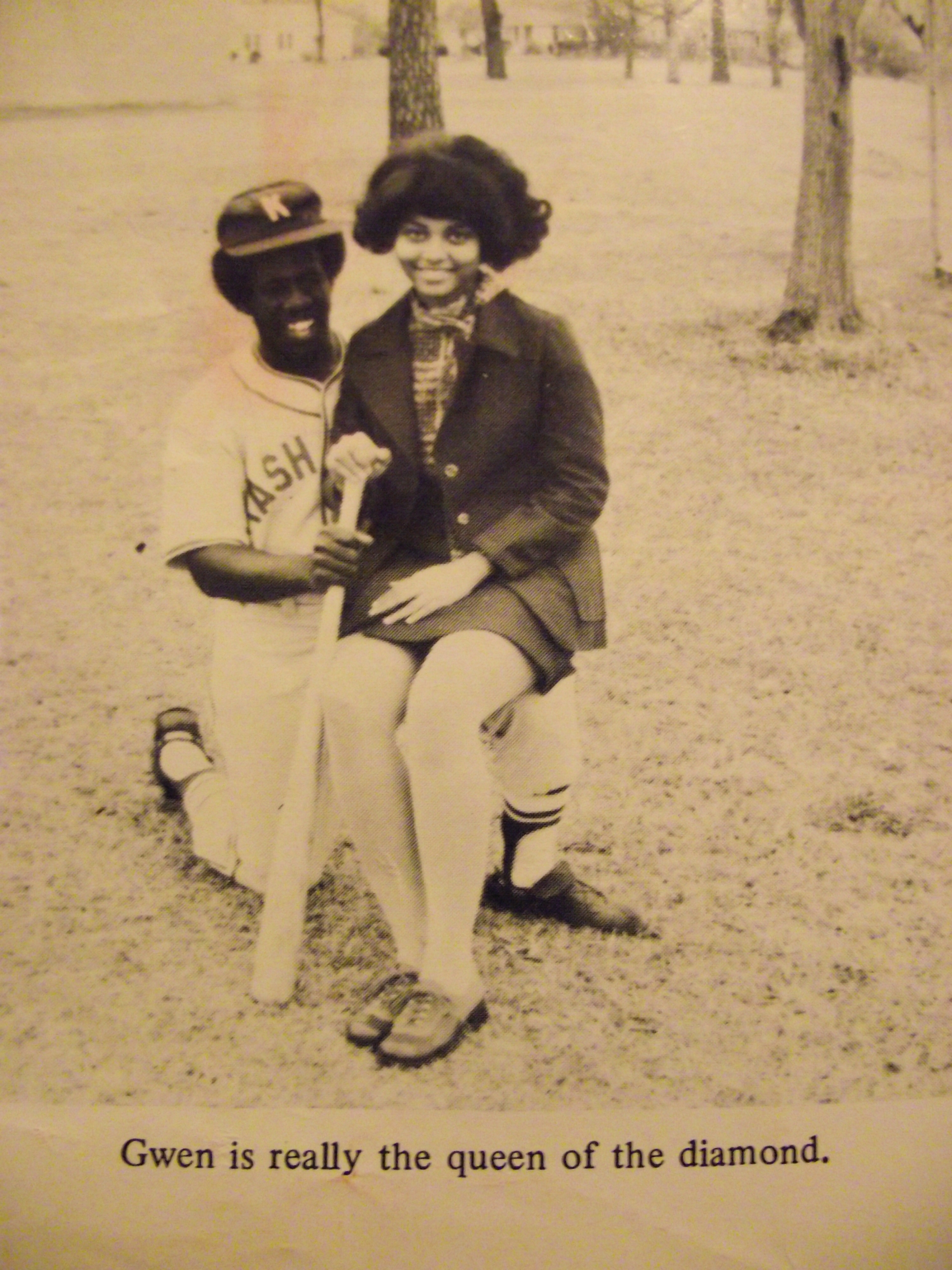 A man and woman sitting on the ground.