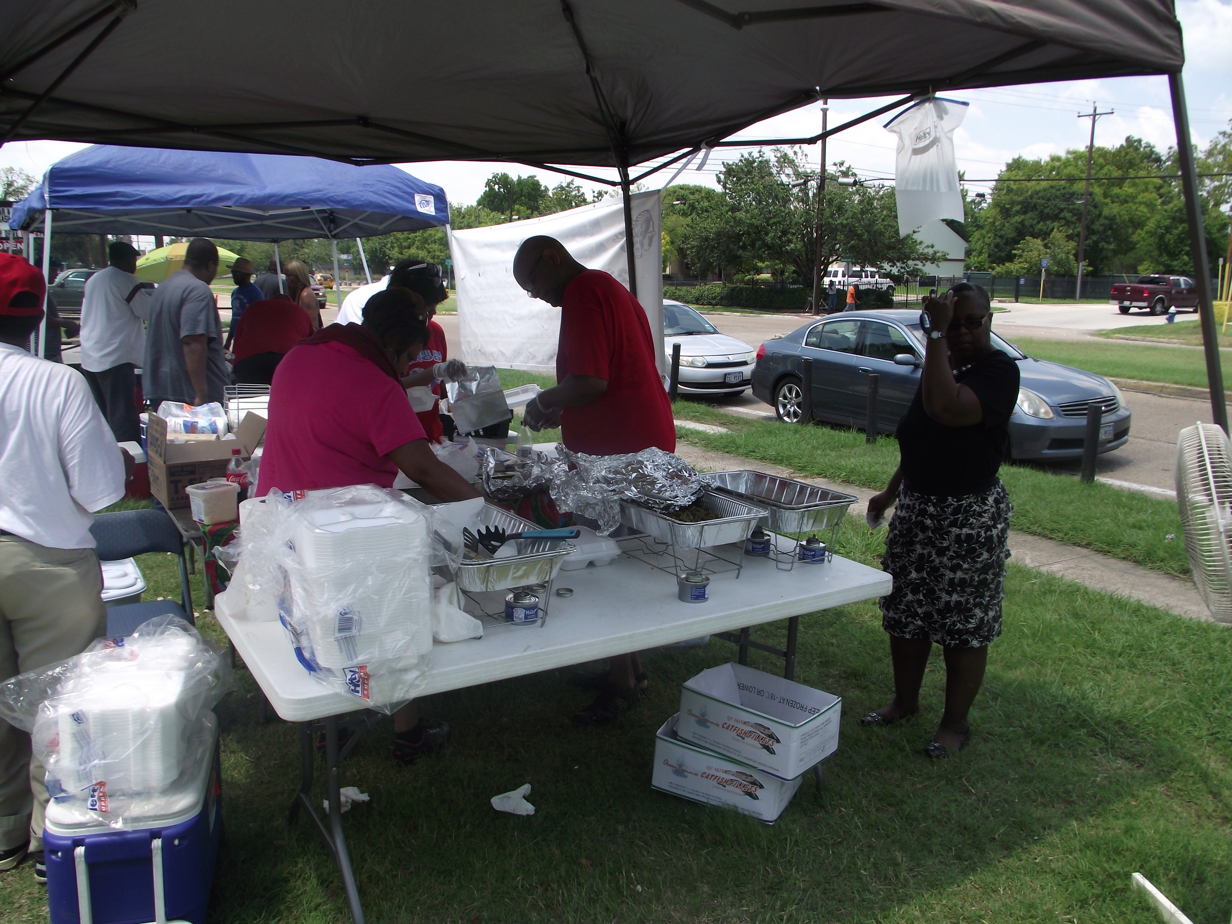 A group of people standing around a table.
