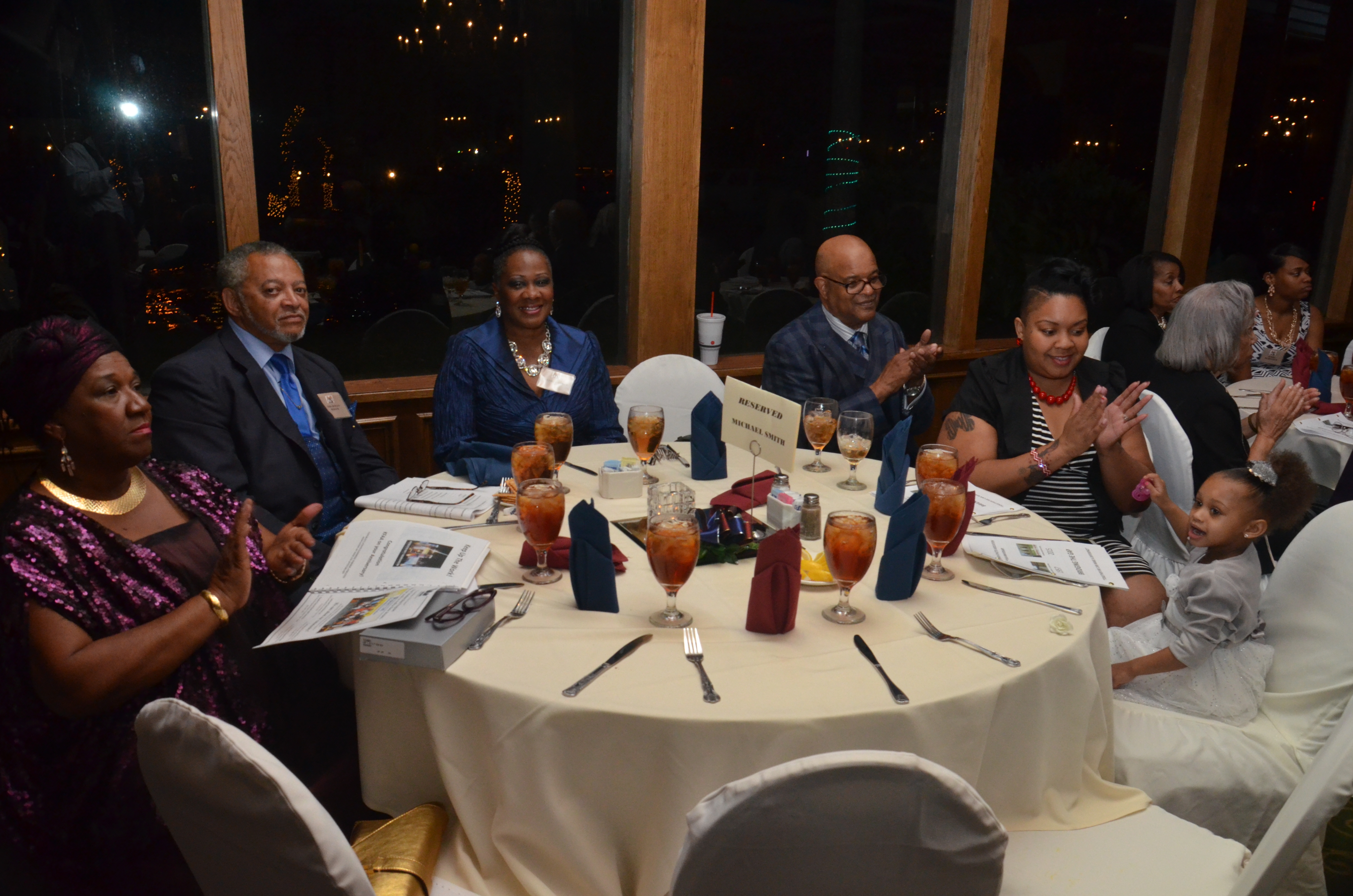 A group of people sitting around a table.