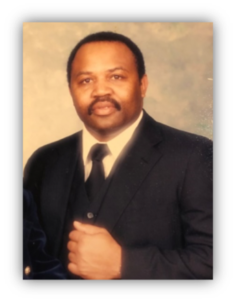 Man in suit with neutral expression.