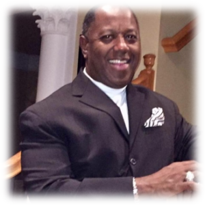Smiling man in a suit indoors.