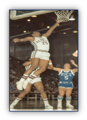 Basketball player shooting towards the hoop.