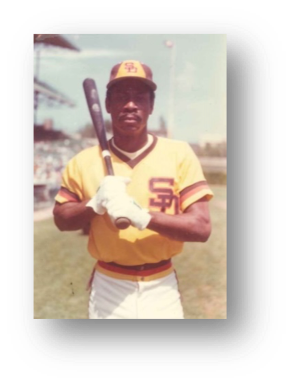 Baseball player holding bat on field.