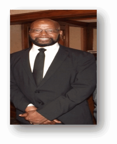 Man in a suit and tie smiling.