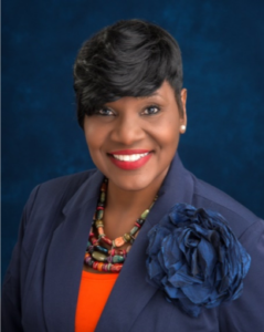 Smiling woman in a blue suit.