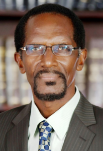 Man in glasses with a suit and tie.
