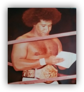 Wrestler reading note in the ring.