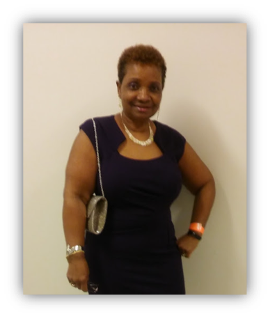 Woman smiling in a black dress.