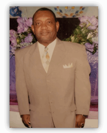 Man in suit with floral backdrop.