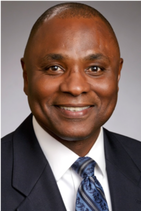 Smiling man in suit and tie.