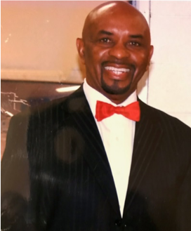 Man in suit with red bow tie.