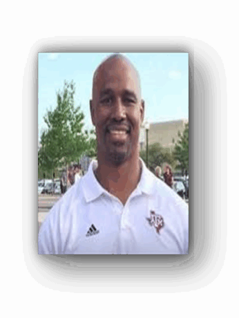 Smiling man in white polo shirt.