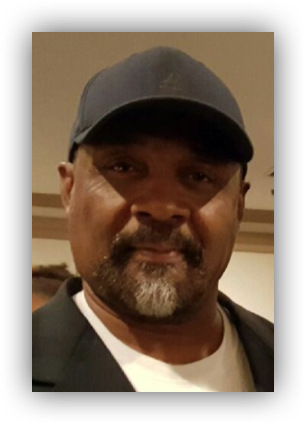 Man wearing a cap and jacket.