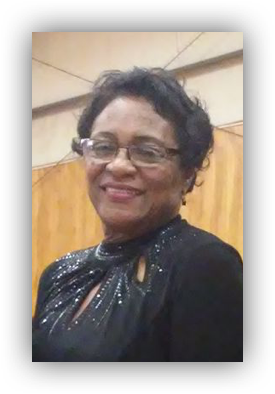Smiling woman wearing glasses and black dress.