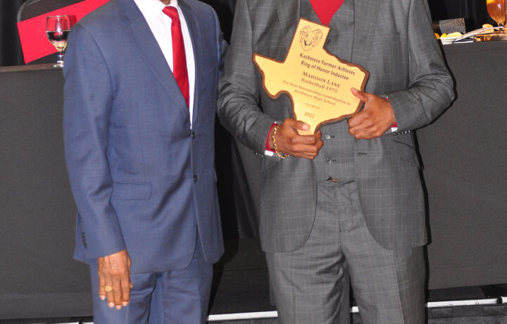 Two men standing next to each other holding a plaque.