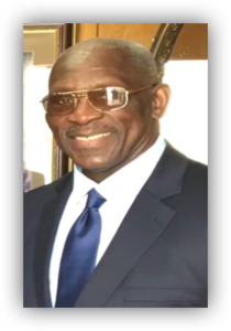 Smiling man in suit and glasses.