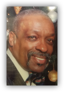 Smiling man in suit with festive background.