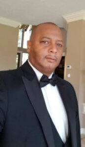 Man in a tuxedo indoors.