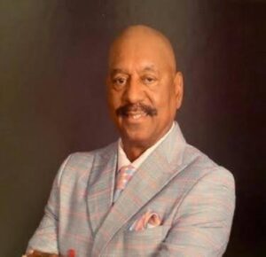 Smiling man in plaid suit portrait.