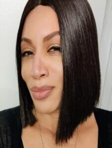 Woman with straight, shoulder-length dark hair.