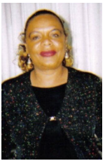 Smiling woman in sparkly black outfit.