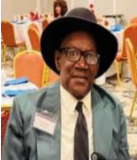 Man wearing hat and glasses at event.